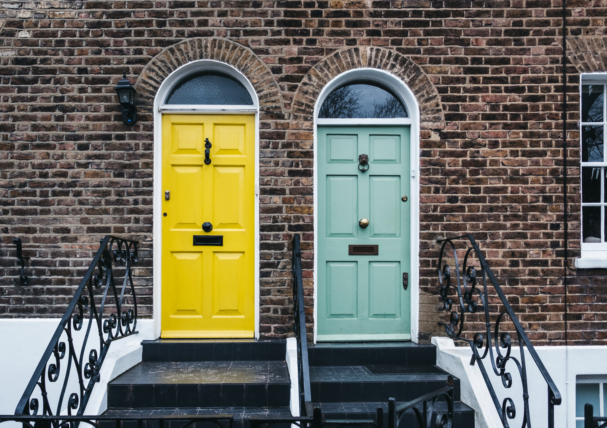 Bright yellow and green door on a English house in London, UK.